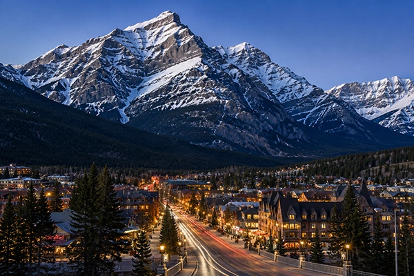Snowy mountain town street with glowing lights